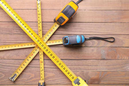 Measuring tapes on wooden backgroundの写真素材