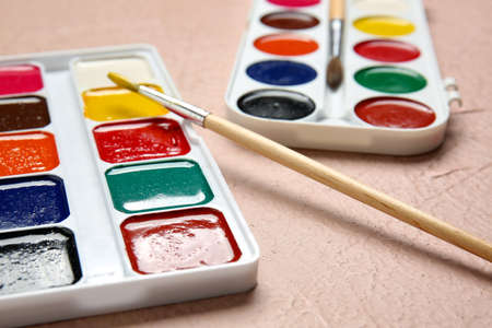 Paints and brushes on color backgroundの写真素材