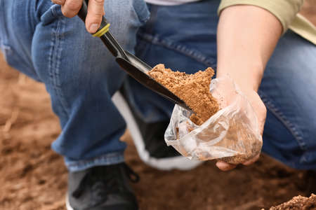 Man testing rich soil outdoors