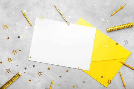 Festive composition with blank card and envelope on gray background