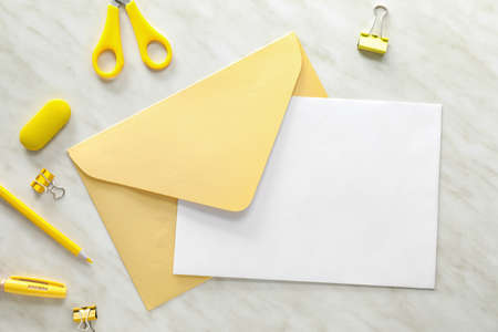 Composition with blank card, envelope and stationery on white backgroundの写真素材