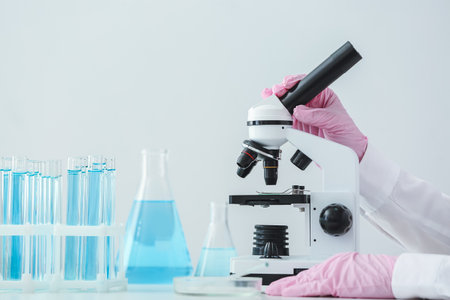 Scientist using microscope in laboratoryの写真素材