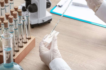 Scientist working with sample in laboratory, closeup