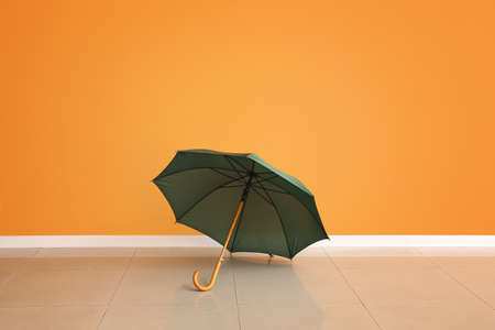 Stylish umbrella near color wallの写真素材