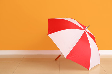 Stylish umbrella near color wallの写真素材