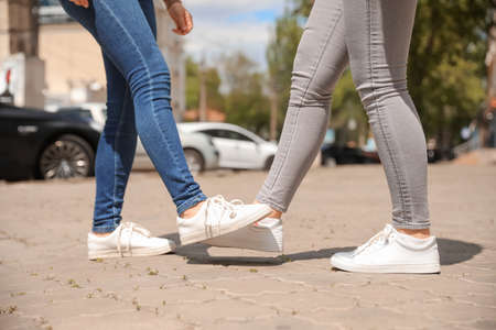Young women greeting each other outdoors. Concept of social distance during coronavirus epidemicの写真素材