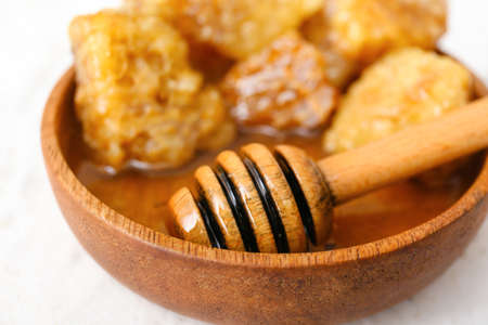 Bowl of sweet honey on table, closeupの写真素材
