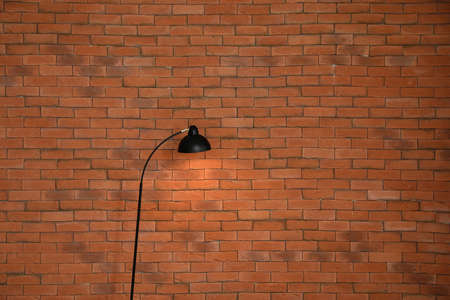 Modern lamp near brick wallの写真素材