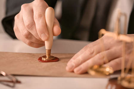 Notary public with stamp working in office, closeupの写真素材