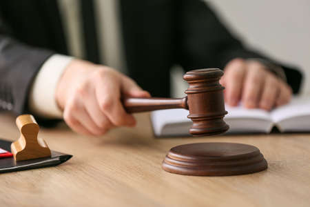 Notary public with judge gavel working in office, closeup