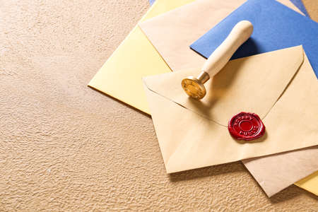 Envelopes with wax seal stamp of notary public on color background