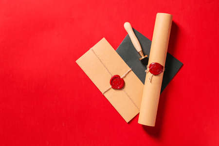 Envelopes and scroll with wax seal stamp of notary public on color backgroundの写真素材