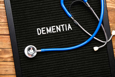 Board with word DEMENTIA and stethoscope on wooden backgroundの写真素材