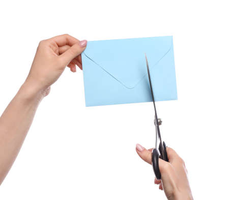 Woman cutting envelope on white backgroundの写真素材