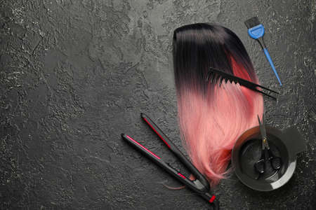 Unusual wig with hairdresser supplies on dark backgroundの写真素材