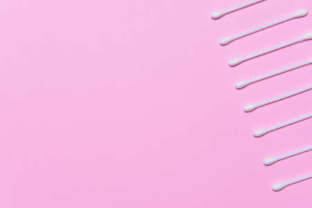 Cotton cosmetic swabs on color background
