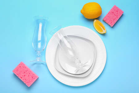 Clean tableware with sponges on color backgroundの写真素材