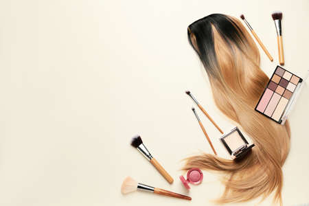 Unusual wig with makeup cosmetics on light backgroundの写真素材