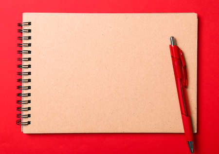 Notebook with pen on color backgroundの写真素材