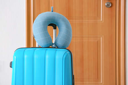 Packed suitcase and travel pillow at homeの写真素材