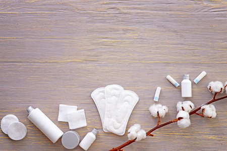 Cotton flowers with cosmetics and personal supplies on tableの写真素材