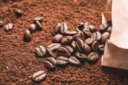 Paper bag with roasted coffee beans on powderの写真素材
