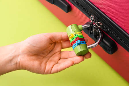 Woman with lock on suitcase, closeupの写真素材