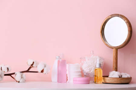 Cotton flowers with cosmetics and supplies on tableの写真素材