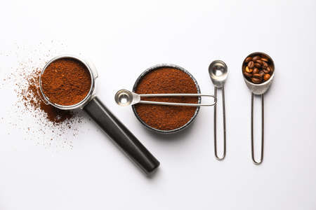 Composition with coffee powder and beans on white backgroundの写真素材