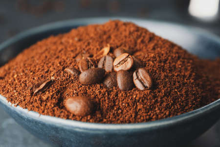 Bowl with coffee powder and beans, closeupの写真素材