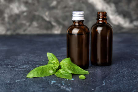 Bottles of basil essential oil on tableの写真素材