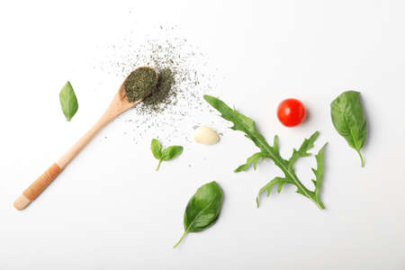 Composition with basil, tomatoes and spices on white backgroundの写真素材