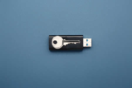 USB flash drive with key on color backgroundの写真素材