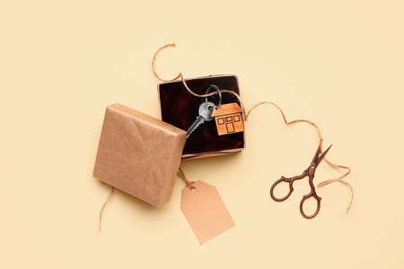 Gift box with key from house on color backgroundの写真素材
