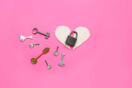 Paper heart with padlock and keys on color backgroundの写真素材