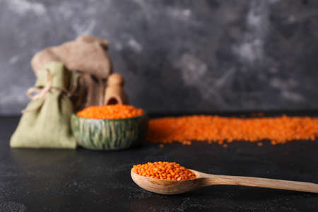 Spoon with red lentils on tableの写真素材