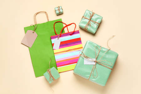 Paper shopping bags and gifts on color backgroundの写真素材
