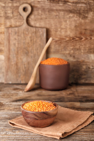 Bowl with red lentils on wooden backgroundの写真素材