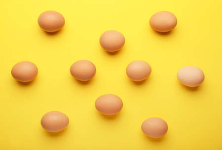 Fresh chicken eggs on color backgroundの写真素材