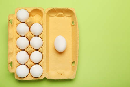 Fresh chicken eggs on color background