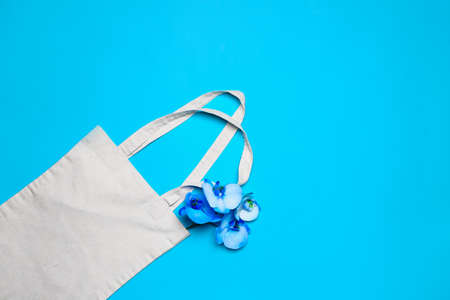 Eco bag with flowers on color backgroundの写真素材