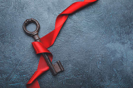 Key with ribbon on dark background