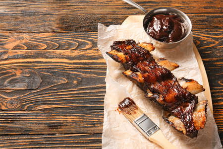 Tasty beef short ribs with sauce on tableの写真素材