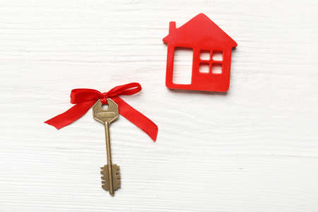 Key from house on white wooden backgroundの写真素材
