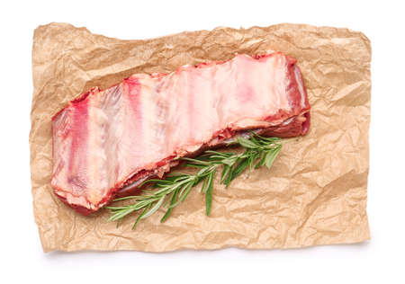 Raw beef short ribs with herbs on white backgroundの写真素材