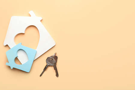 Keys from house on color background