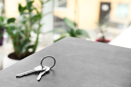 Keys from house on table in roomの写真素材