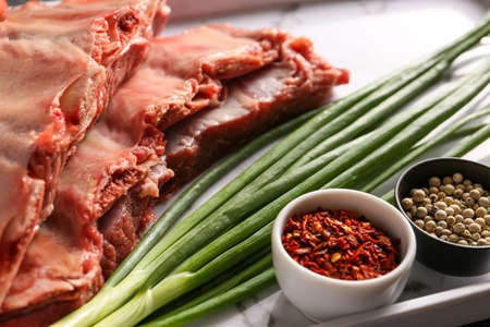 Raw beef short ribs with spices on plate, closeupの写真素材