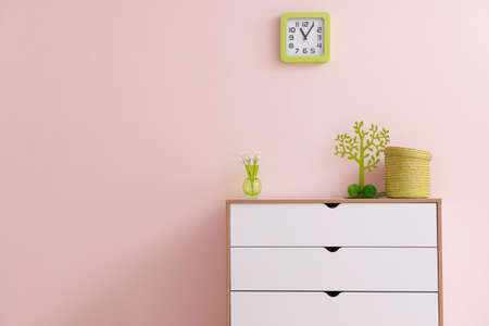 Modern chest of drawers with decor near color wall in room