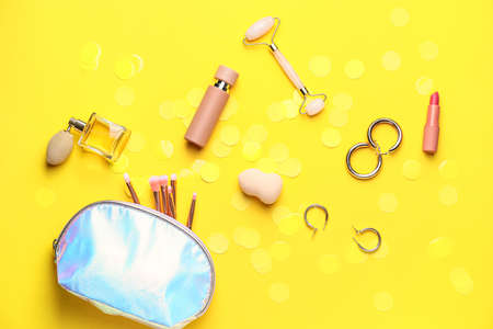 Composition with decorative cosmetics on color background